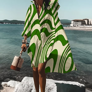 Green Wave Pattern Hooded Beach Poncho worn by a person standing outdoors near water, showcasing the vibrant green design and lightweight fabric, suitable for summer beach cover-up in size 5XL.