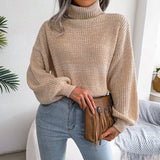 Green women's chunky cable knit high-neck wool sweater with long sleeves and a textured design.
