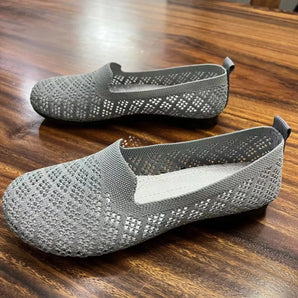 Gray lightweight breathable slip-on shoes designed for outdoor activities, featuring a water-resistant material with a subtle pattern, suitable for walking and athletic use.