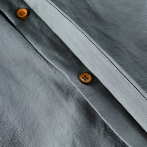 Grey Henley shirt made from soft cotton featuring a classic collar, wooden buttons, and long sleeves, designed for casual menswear.