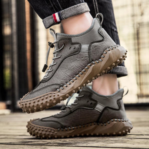Grey high-top outdoor sneakers with anti-slip and shock-absorbing features, designed for durability and comfort. The sneakers combine elements of fashion and sportswear, suitable for walking and hiking.