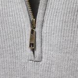 A soft, breathable grey knit winter beanie made from textured fabric displayed against a plain background, showcasing its simple yet stylish design.