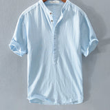 Heavenly blue linen button-up shirt in size XL, featuring a classic collar, long sleeves, and a row of buttons down the front. The shirt is designed for breathability and sustainability, ideal for summer fashion, with a soft grey hue visible in certain light.