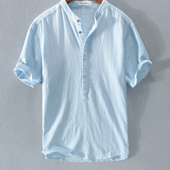 Heavenly blue linen button-up shirt in size XL, featuring a classic collar, long sleeves, and a row of buttons down the front. The shirt is designed for breathability and sustainability, ideal for summer fashion, with a soft grey hue visible in certain light.