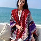 Colorful handmade woolen Bohemian poncho in red with a plaid pattern, featuring a loose fit with neck and sleeve details, ideal for winter fashion.