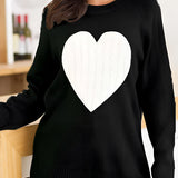 Women's oversized grey sweater with a heart pattern, showcasing a cozy knit texture. The sweater has long sleeves and a wide neckline, designed for comfort and style.