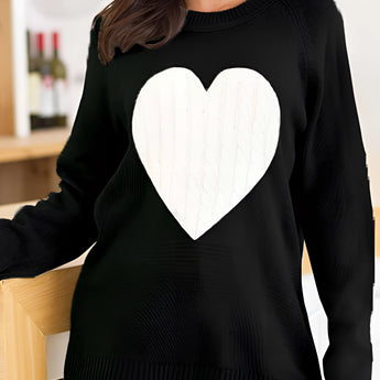 Women's oversized grey sweater with a heart pattern, showcasing a cozy knit texture. The sweater has long sleeves and a wide neckline, designed for comfort and style.