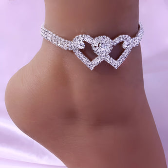 Elegant Heart-Shaped Diamond Bridal Anklet displayed on a woman's ankle, showcasing intricate design and sparkling gemstones, perfect for wedding foot jewelry.