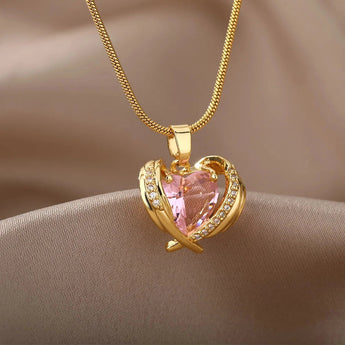 Heart-shaped pink gemstone gold necklace with diamond-encrusted heart pendant, featuring a delicate gold chain.