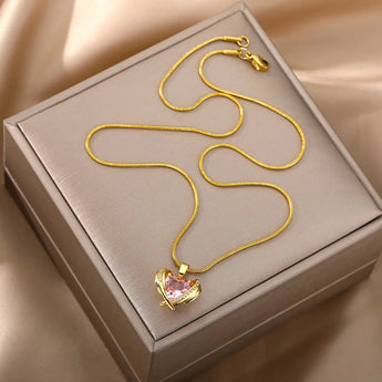 Heart-shaped pink gemstone gold necklace with diamond-encrusted heart pendant.