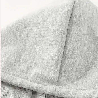 Heather grey women's lightweight casual pullover hoodie displayed on a couch, showcasing the soft fabric and comfortable design, ideal for cozy fall fashion.