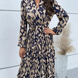 Woman wearing a marine blue, high-neck, long sleeve leopard print dress, posing with her arm slightly raised, showcasing trendy fall fashion in size XL.