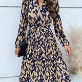 Woman wearing a high-neck long sleeve leopard print dress suitable for trendy fall fashion, showcasing a stylish and chic look.