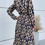 High-neck long sleeve leopard print dress featuring a trendy fall fashion design, with a fitted shoulder and leg silhouette.