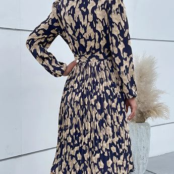 High-neck long sleeve leopard print dress featuring a trendy fall fashion design, with a fitted shoulder and leg silhouette.