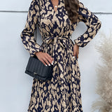 Woman wearing a high-neck, long sleeve leopard print dress, standing with her hand on her hip, showcasing trendy fall fashion.