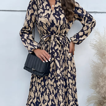 Woman wearing a high-neck, long sleeve leopard print dress, standing with her hand on her hip, showcasing trendy fall fashion.