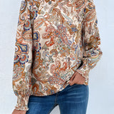 
A stylish beige high-neck paisley blouse in size 2XL, featuring a bohemian design with long sleeves and a detailed collar, perfect for an autumn wardrobe.