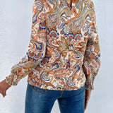High-neck paisley blouse featuring a stylish bohemian design with long sleeves and a fitted waist, ideal for autumn wear.