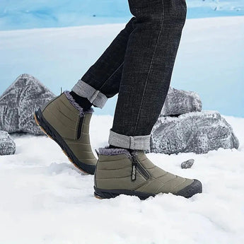 High-traction anti-slip rubber sole athletic sneakers being worn outdoors in a snowy environment, paired with jeans, showcasing their durability and grip in freezing conditions.