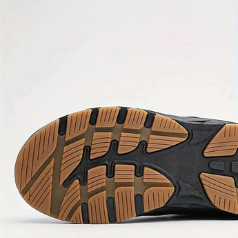 High-traction athletic sneakers featuring anti-slip synthetic rubber soles, designed for outdoor use. The sneakers are set against a hardwood floor background, showcasing their durability and stylish design.