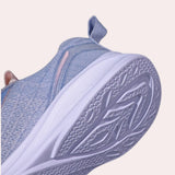 A pair of high-traction women's sneakers featuring a durable non-slip sole; the sneakers are primarily in a grey color with electric blue accents.