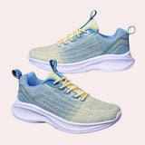 Blue and yellow high-traction women's sneakers with a durable non-slip sole, featuring a sporty design suitable for walking and running activities.