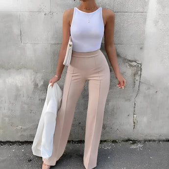 High-waist black slim fit trousers featuring a contrast stripe, shown on a model standing. The model is wearing a long-sleeve top and sunglasses, emphasizing the waist and fit of the trousers. The variant shown is in apricot color, size 2XL.