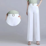 A white blazer paired with high-waist black wide-leg trousers, showcasing an elegant formal business attire.