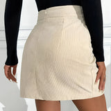 A woman wearing a high waist ribbed mini skirt in a casual chic autumn fashion style, paired with a white top and black outerwear, showcasing a modern and trendy look.