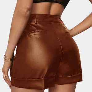 Brown faux leather high-waisted women's shorts, ideal for parties, showcasing a sleek and stylish design with a fitted waist and thigh-length cut.