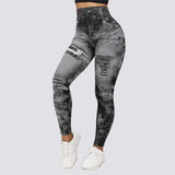 High-waisted distressed denim print leggings in gray, shown in plus size 4XL/5XL, highlighting their stretchy fit on the legs and knees.