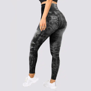 High-waisted distressed denim print leggings featuring a stretchy jegging design, highlighting elements like the waist, thigh, and knee areas, styled to resemble denim with a fashionable, sporty look.