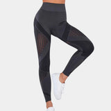 Gray high-waisted yoga pants in XL size, featuring a geometric design, shown on a person demonstrating flexibility and movement with a focus on the leg and waist areas.