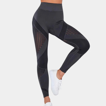 Gray high-waisted yoga pants in XL size, featuring a geometric design, shown on a person demonstrating flexibility and movement with a focus on the leg and waist areas.