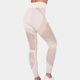 Khaki high-waisted geometric yoga pants in size XL, showcasing the breathable and stretchable fabric worn by a person with bare feet, highlighting the comfortable fit around the legs and waist.