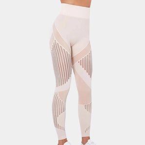 High-waisted geometric yoga pants featuring a breathable and stretchable fabric, designed for activewear, shown being worn by a person.