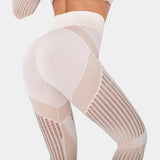 High-waisted geometric yoga pants in a breathable, stretchable fabric, showcasing a white geometric pattern; the image focuses on the human body from the waist down, highlighting leg coverage and fit around the waist, thigh, and knee.