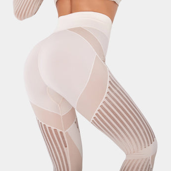 High-waisted geometric yoga pants in a breathable, stretchable fabric, showcasing a white geometric pattern; the image focuses on the human body from the waist down, highlighting leg coverage and fit around the waist, thigh, and knee.