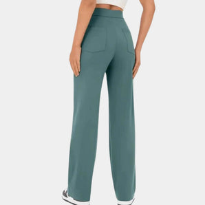 High-waisted teal wide-leg palazzo pants designed for versatile office wear, showcasing a loose, flowing fit and elegant style.