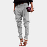 
A pair of stylish high-waisted white women's trousers with a tailored fit, modeled with a chic ivory appearance, suitable for formal or casual wear.