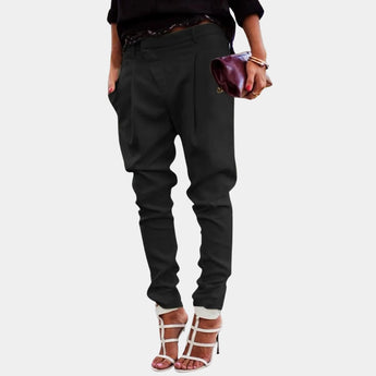 A pair of high-waisted black women's trousers styled with a chic tailored fit, showcased on a model wearing a 3XL size. The image highlights the elegance and sophistication of the pants.