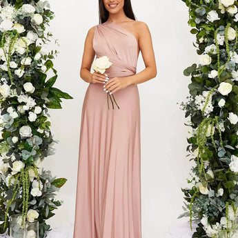 Ivory backless crossover strap bridesmaid maxi dress with pockets, shown in blush pink, featuring elegant one-piece design with delicate floral details and a sophisticated shoulder neckline.