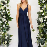Ivory backless bridesmaid maxi dress with crossover straps and pockets, featuring an elegant design with a fitted waist and flowing skirt.