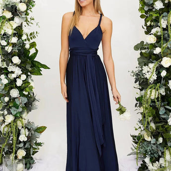 Ivory backless bridesmaid maxi dress with crossover straps and pockets, featuring an elegant design with a fitted waist and flowing skirt.