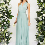 Ivory backless crossover strap bridesmaid maxi dress with pockets, featuring a flowing silhouette. The dress is displayed on a model with long hair, revealing the elegant backless design and crossover straps.