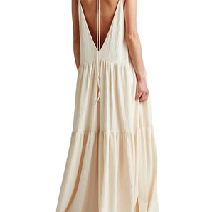 Ivory backless maxi dress featuring elegant tiered layers, thin straps, and a flowing silhouette, suitable for evening events.