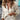 Ivory Bohemian Deep V-Neck Crochet Blouse in apricot color, featuring a casual chic style with long sleeves and intricate crochet detailing, modeled by a person wearing sunglasses.