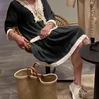Ivory Boho Chic Lace Trim Tunic styled as a lightweight summer dress, featuring delicate lace details. The dress is paired with sandals and accessories like eyewear and jewelry, showcasing a fashionable summer look.