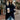 Ivory chunky knit sweater with a buttoned cowl neck, displayed in a blue 3XL size, showcasing its oversized design ideal for women's fashion. The photograph highlights the garment's texture and style, emphasizing the long sleeves and cozy fit.